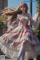 A woman in a pink and white dress is posing for a picture.