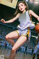 A woman in a basketball uniform holding a basketball on a court.